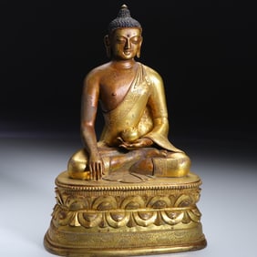 A bronze gilt statue of Medicine Buddha