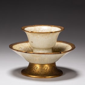A piece of porcelain-clad gold cup