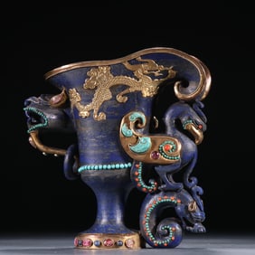 A piece of lapis lazuli inlaid with gemstones and a golden phoenix cup