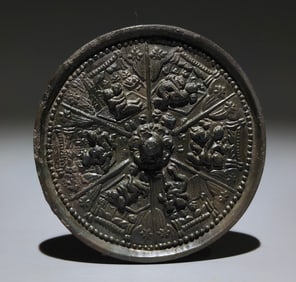 A small hand mirror with a Song Acacia pattern