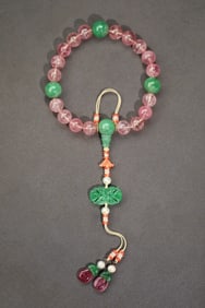 A piece of court beads rubellite eighteen sons pressed in the hand