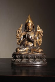 A gilded bronze statue of Master Atixia