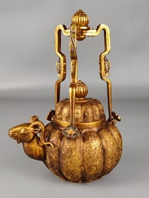 A copper-gilt sheep's head jug