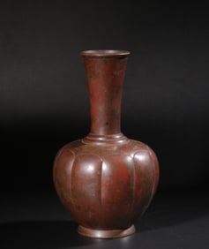 A clear copper vase with chrysanthemum petals