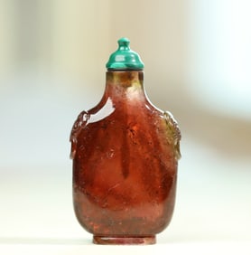 An old tourmaline caramel-colored tourmaline beast head ring snuff bottle