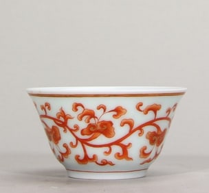 A piece of Qingdao light alum red painted gold entwined branch lotus pattern tea round