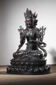 An overseas rosewood material carved Guanyin sitting statue