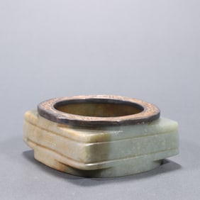 A piece of river mill jade wrapped with silver gilt jade