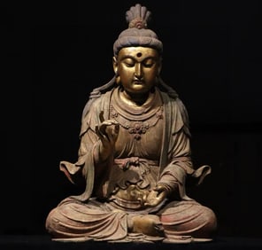 A piece of wood carving, painted with gold, seated statue of Guanyin