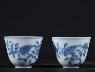 A pair of Ming Dynasty Chenghua blue and white flower and bird cups