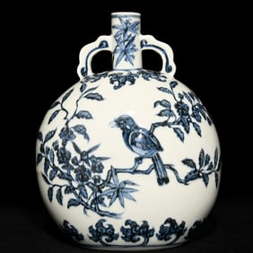 A flat vase with blue and white flowers and birds