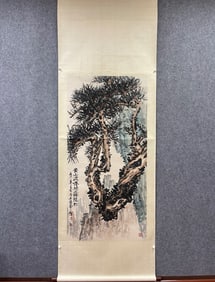 A vertical scroll on paper by Wu Fuzhi descending the dragon pine