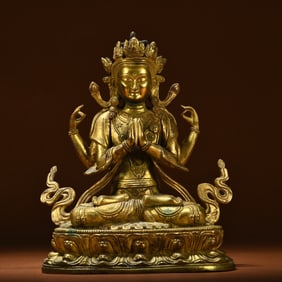 A Qing Dynasty bronze gilt four-armed Guanyin statue