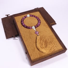 A piece of Qing Dynasty ruby eighteen sons in hand