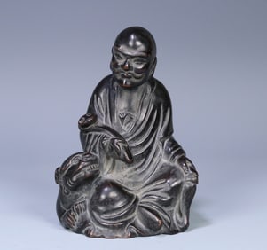 A Qing Dynasty small-leaf rosewood arhat ornament