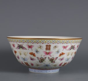 A large bowl of pastel hundred butterflies painted with gold and Chinese characters in the year of