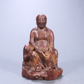 A Qing Dynasty agarwood carved bangs play golden toad ornament