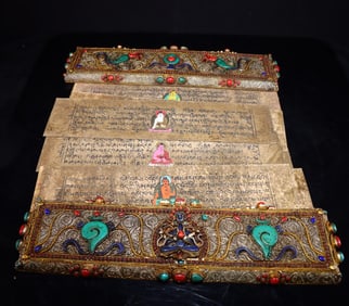 A Tibetan silver filigree inlaid with precious stones