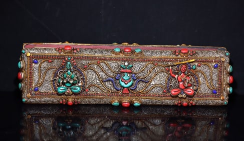A Tibetan silver filigree inlaid with precious stones