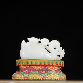 A Qing Dynasty Hetian jade goose bit lotus ornament