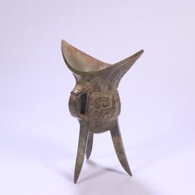 A bronze three-legged cup