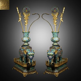 A pair of cloisonné enamel statues are too peaceful