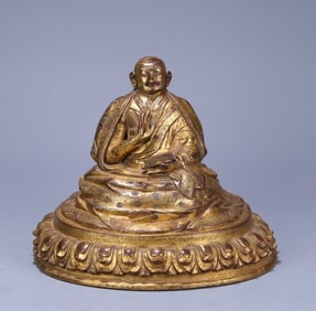 A 17th-century Tibetan bronze gilt statue of a Guru