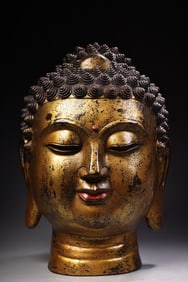 A piece engraved with a gold Shakyamuni Buddha head