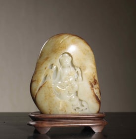 A piece of Hetian jade seed material with skin Guanyin statue ornaments