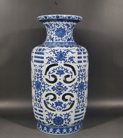 A Qing Qianlong blue and white entwined branch lotus pattern carved hollow gossip turning bottle