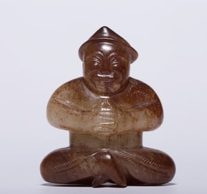 A Hetian jade soil red Qin Xun sitting figurine