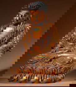 A seated statue of Shakyamuni in clear sandalwood lacquered gold