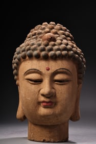 A carved and painted Buddha statue made of wood