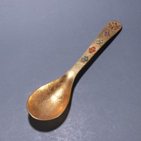 A clear bronze gilt gem-encrusted spoon