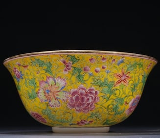 A bowl with a clear material enamel and a floral pattern of entwined lilys