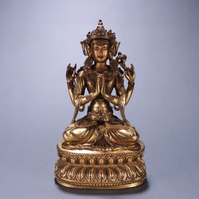 A bronze gilt four-armed statue of Guanyin