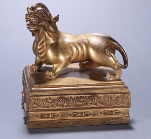 A Qing Dynasty Tibetan bronze gilt beast button seal
