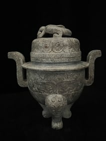 A three-legged incense burner with a jade dragon pattern animal face in the Han Dynasty