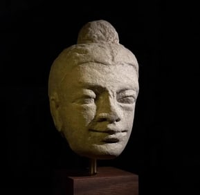 A piece of white plaster clay Buddha head