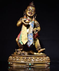 An old bronze hand-engraved statue of the Yellow God of Wealth