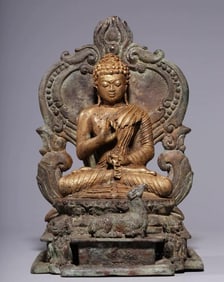 A bronze seated statue of Shakyamuni