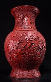 A piece of red lacquerware flowers bloom in a rich bottle