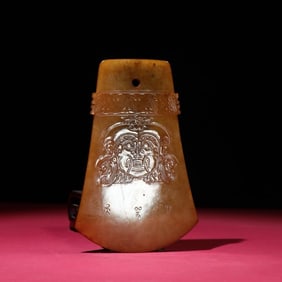 A piece of Huangqin seed material god face axe-shaped device