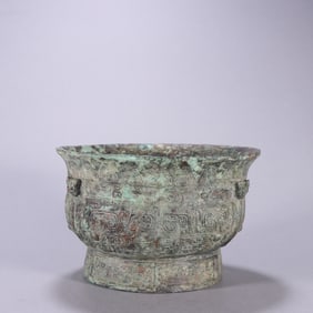A bronze animal face pattern