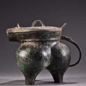 A bronze three-legged wine glass