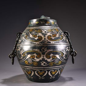 A bronze wrong gold and silver chain jar