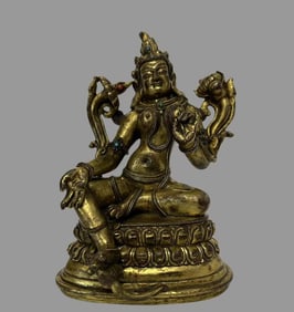 A piece of copper-gilt green Tara