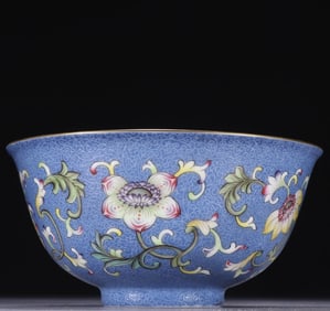 A piece of blue ground lying on the ground with pastel floral pattern bowl