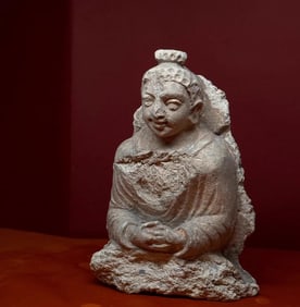 A white-plastered statue of the Buddha