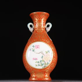 A piece of clear coral red glazed gold window pattern wall vase